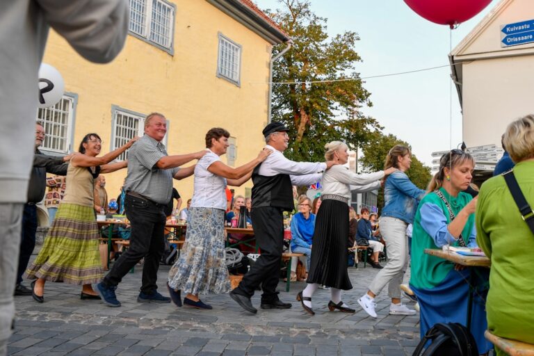 People dancing in a line outdoors